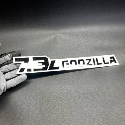Custom 7.3L Godzilla V8 truck emblem with aggressive styling for Super Duty accessory listing.