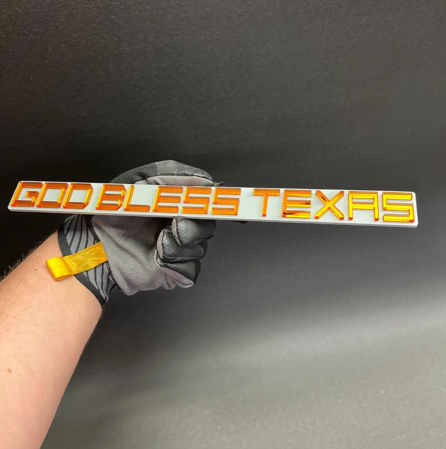 Custom God Bless Texas text badge in glossy acrylic finish for truck grille tailgate and automotive exterior