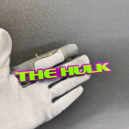 Green and purple The Hulk car badge with raised 3D lettering