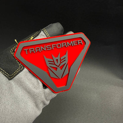 Custom Transformers Decepticon car fender emblem with glossy red background and silver robot insignia for Jeep Wrangler styling.