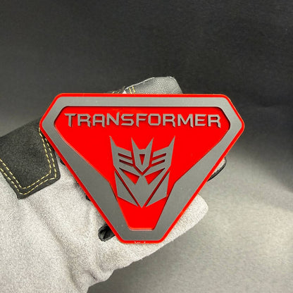 Transformer Decepticon Badlands shield emblem for Ford Bronco Badlands with bold TRANSFORMER lettering and silver robot insignia.