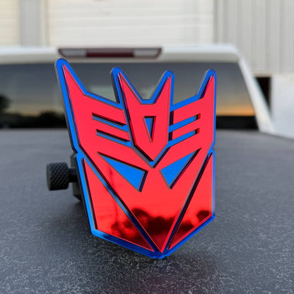 Reflective red and blue Transformers themed hitch cover for Toyota Tacoma pickup truck.