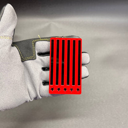 Red and black American patriotic flag car badge fender emblem made from layered acrylic.
