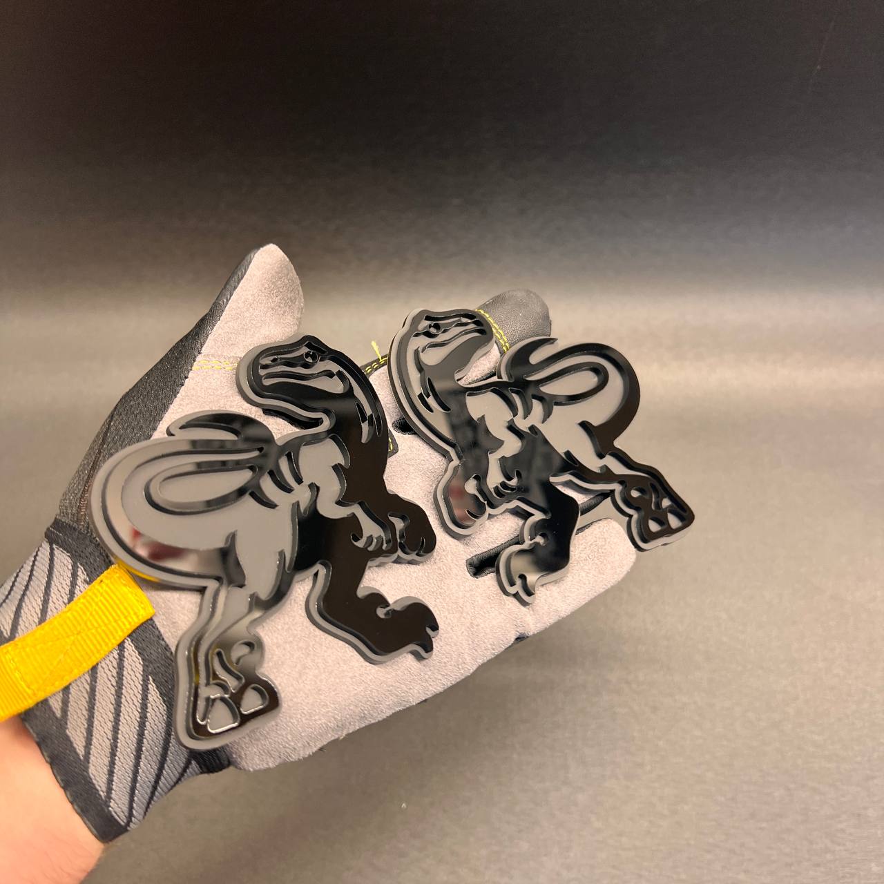 Dinosaur Raptor car and truck emblem with layered black and silver finish