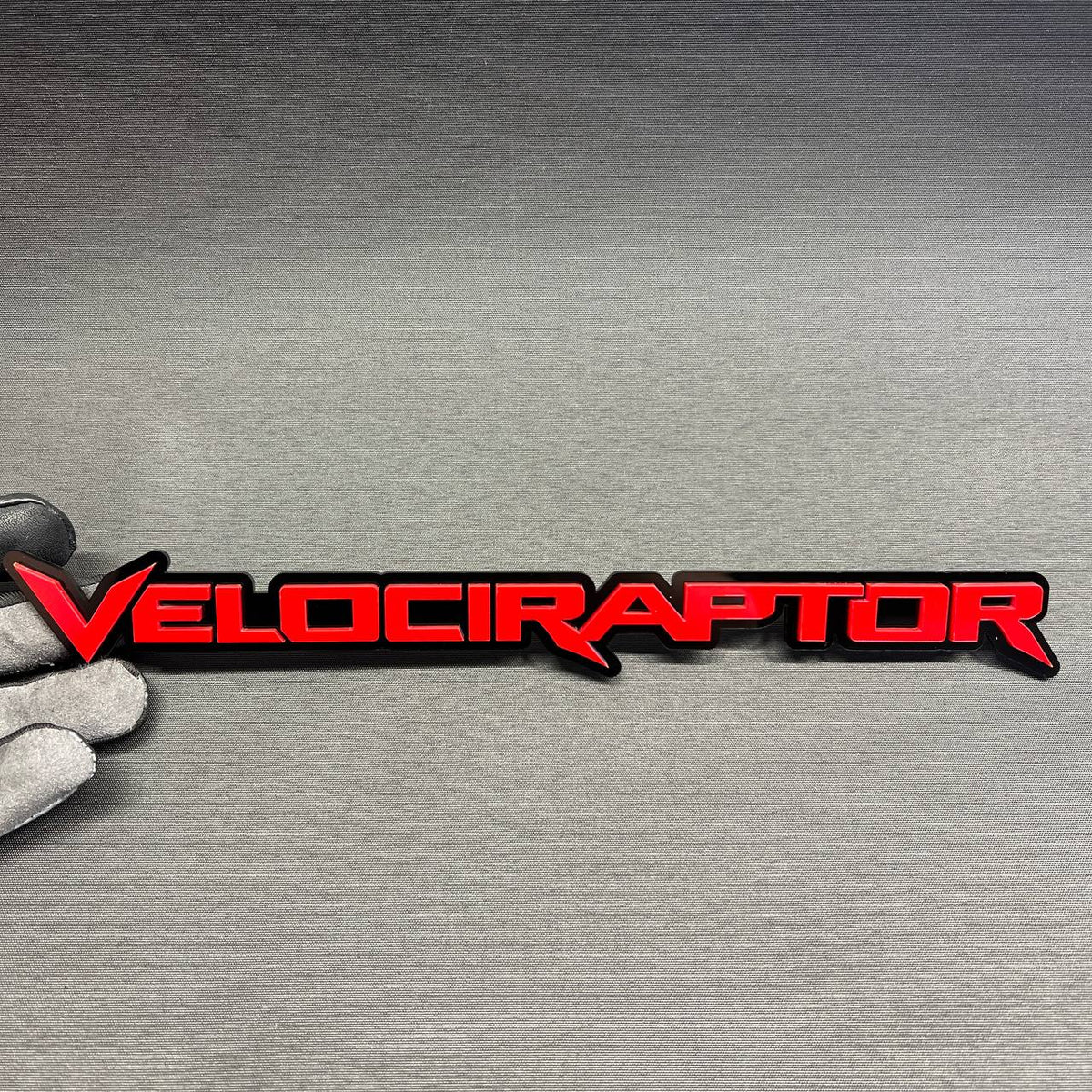 Red and black Velociraptor car emblem badge for Ford, Toyota, GMC, Chevy, Jeep and RAM vehicles