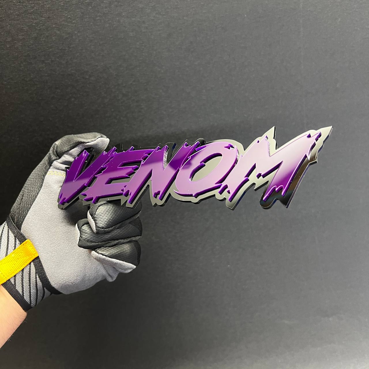 VENOM text Car Badge Fender Emblem with aggressive jagged lettering and 3M-style adhesive backing.