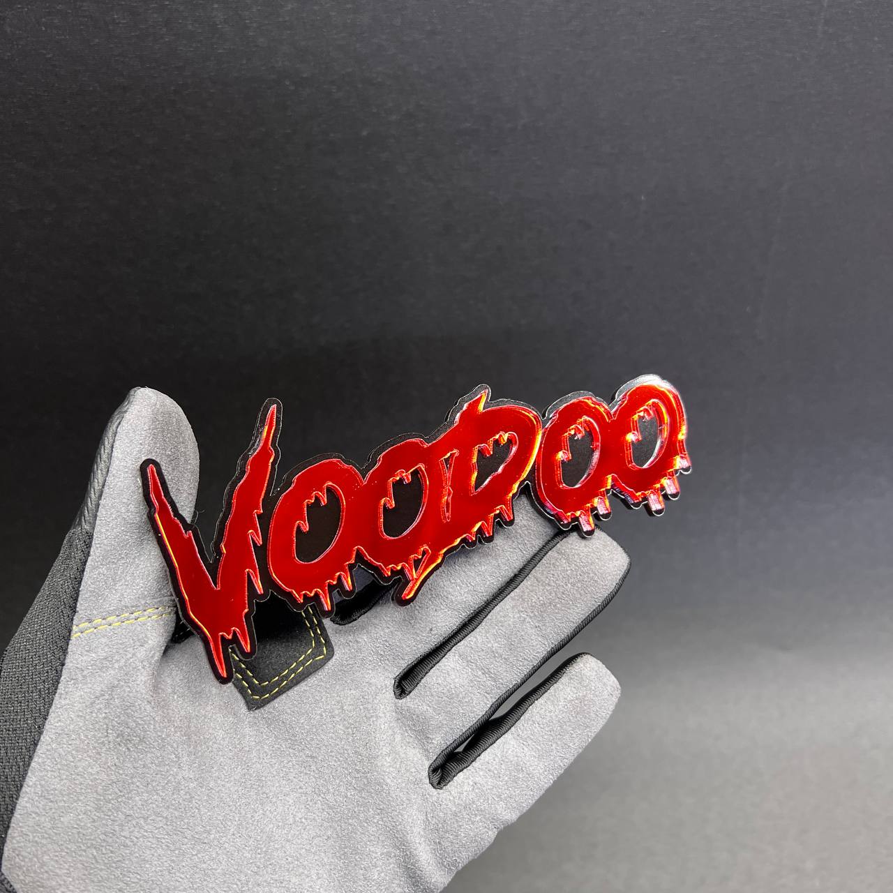 Red and black VOODOO car text badge with a dripping horror-style design