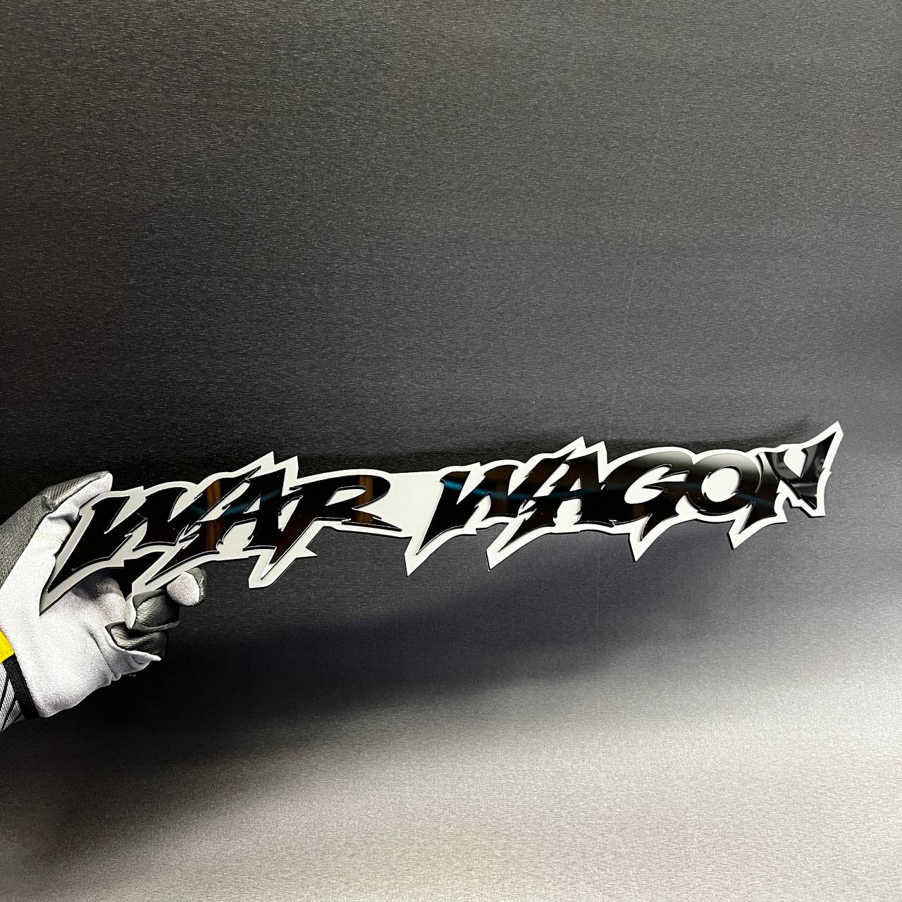 Black War Wagon acrylic car badge with white backing, designed as a custom automotive fender decal.