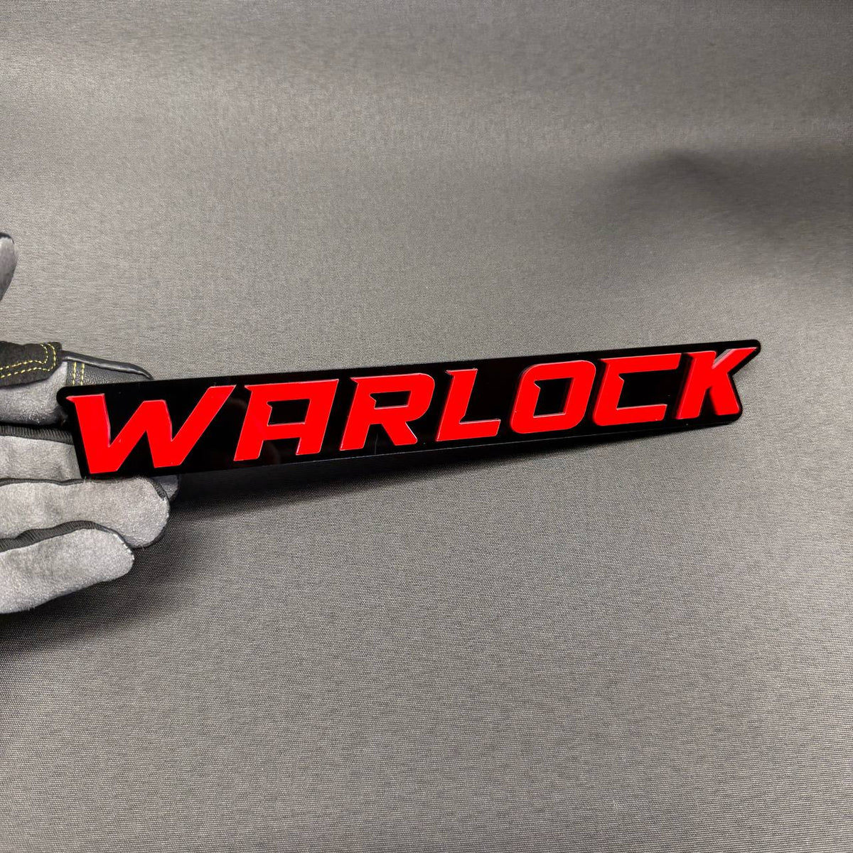 Red WARLOCK automotive badge with black backing for RAM 1500 2500 3500 truck customization