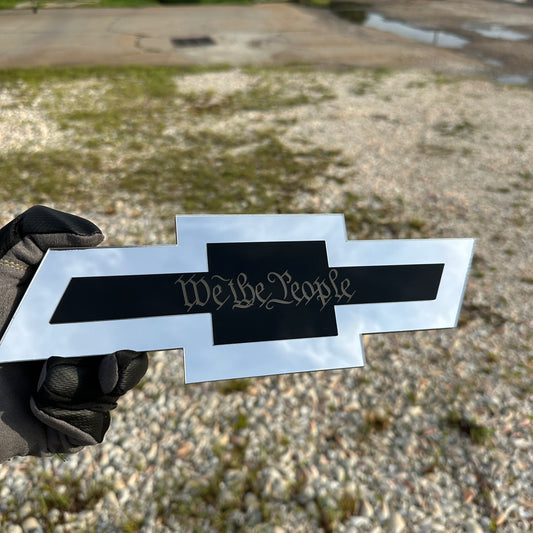 Silver Chevy Bowtie hitch cover with gold Autobot emblem mounted on truck receiver