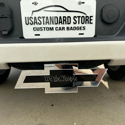 Silver and black Chevy Bowtie We the People hitch cover for truck exterior