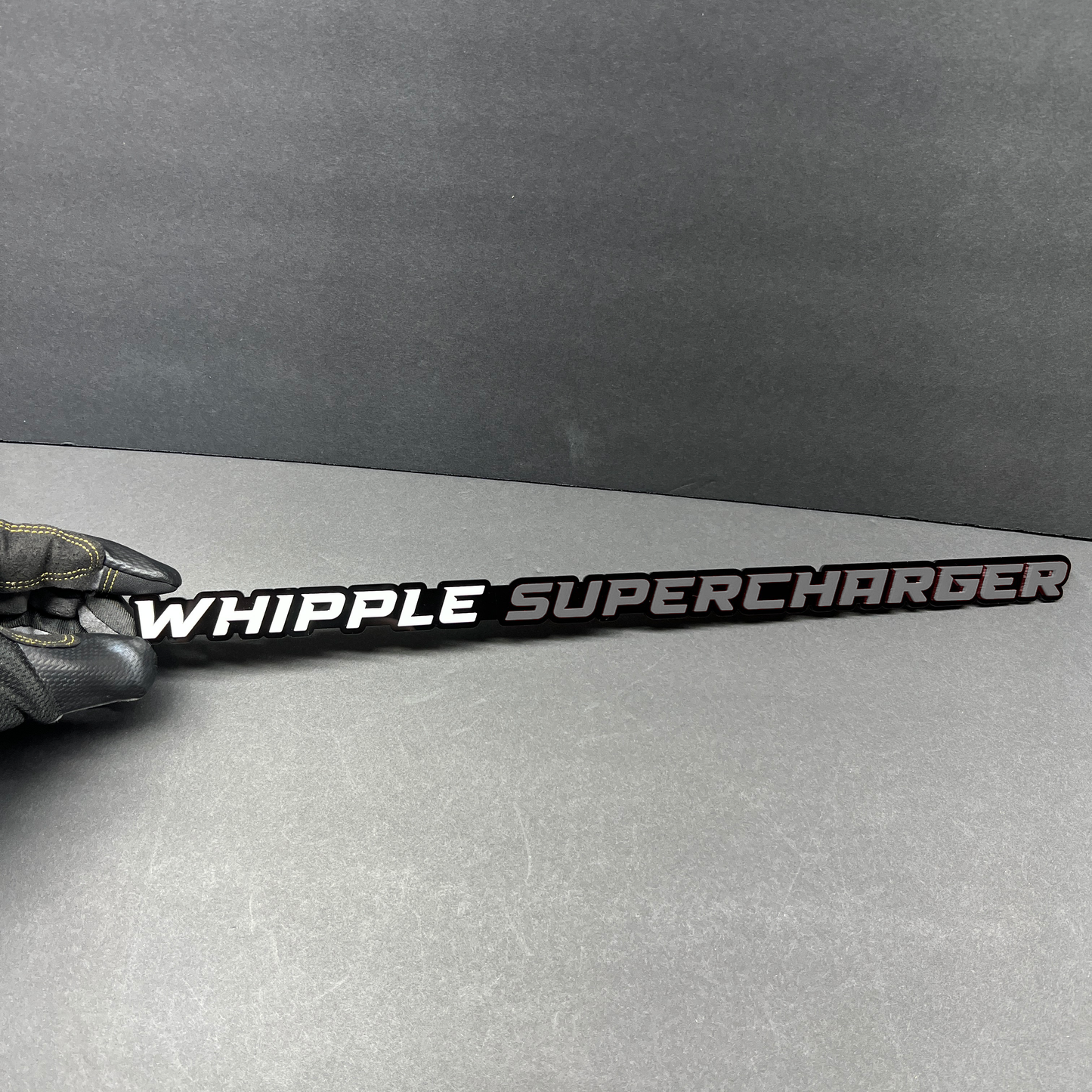 Whipple Supercharger text badge with white and gray lettering