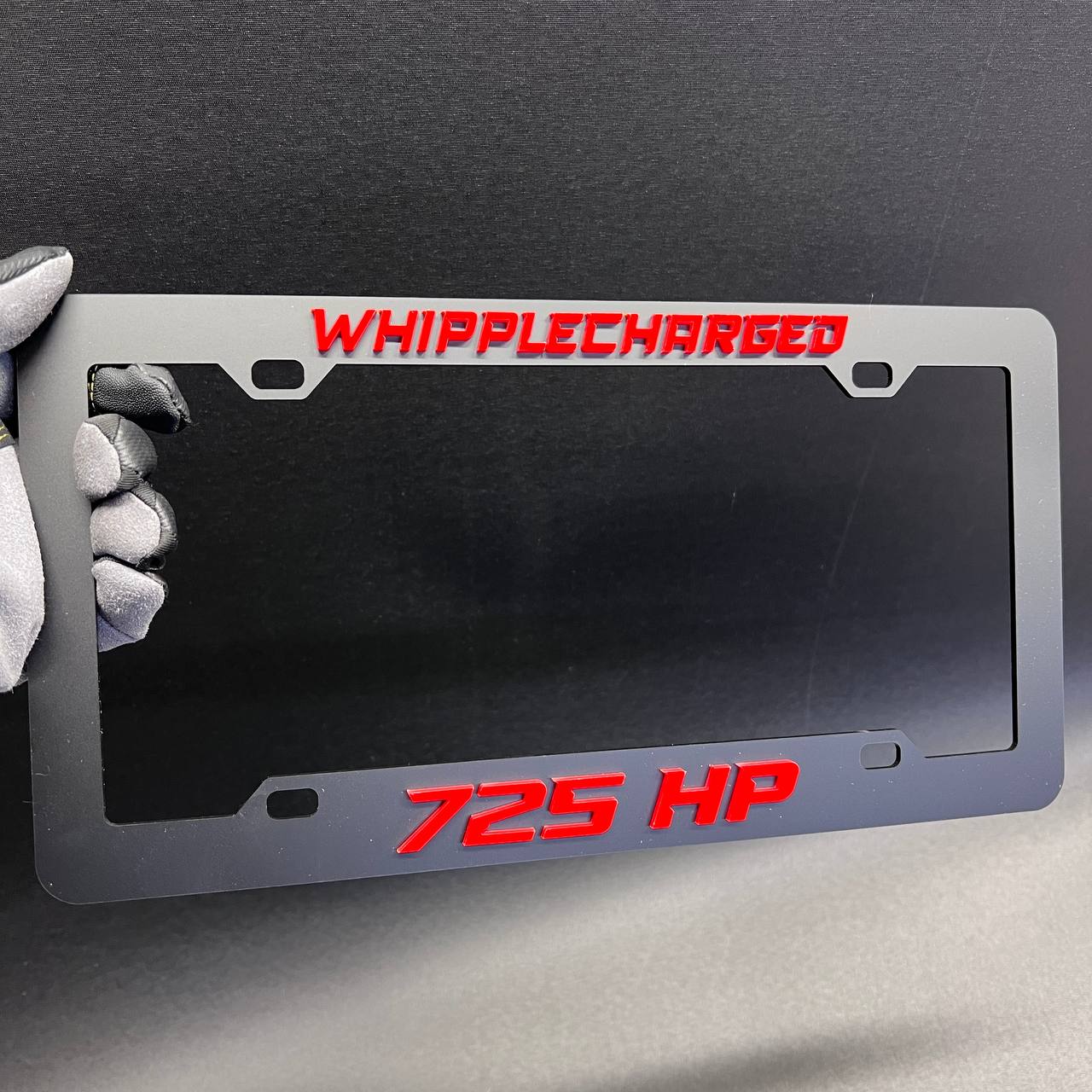 Whipplecharged 725 HP exterior license plate frame for performance car customization.