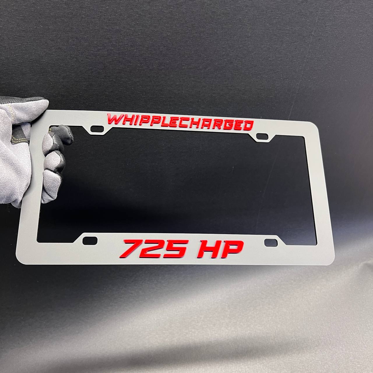 Whipplecharged performance car plate frame with raised 725 HP lettering for custom vehicles.