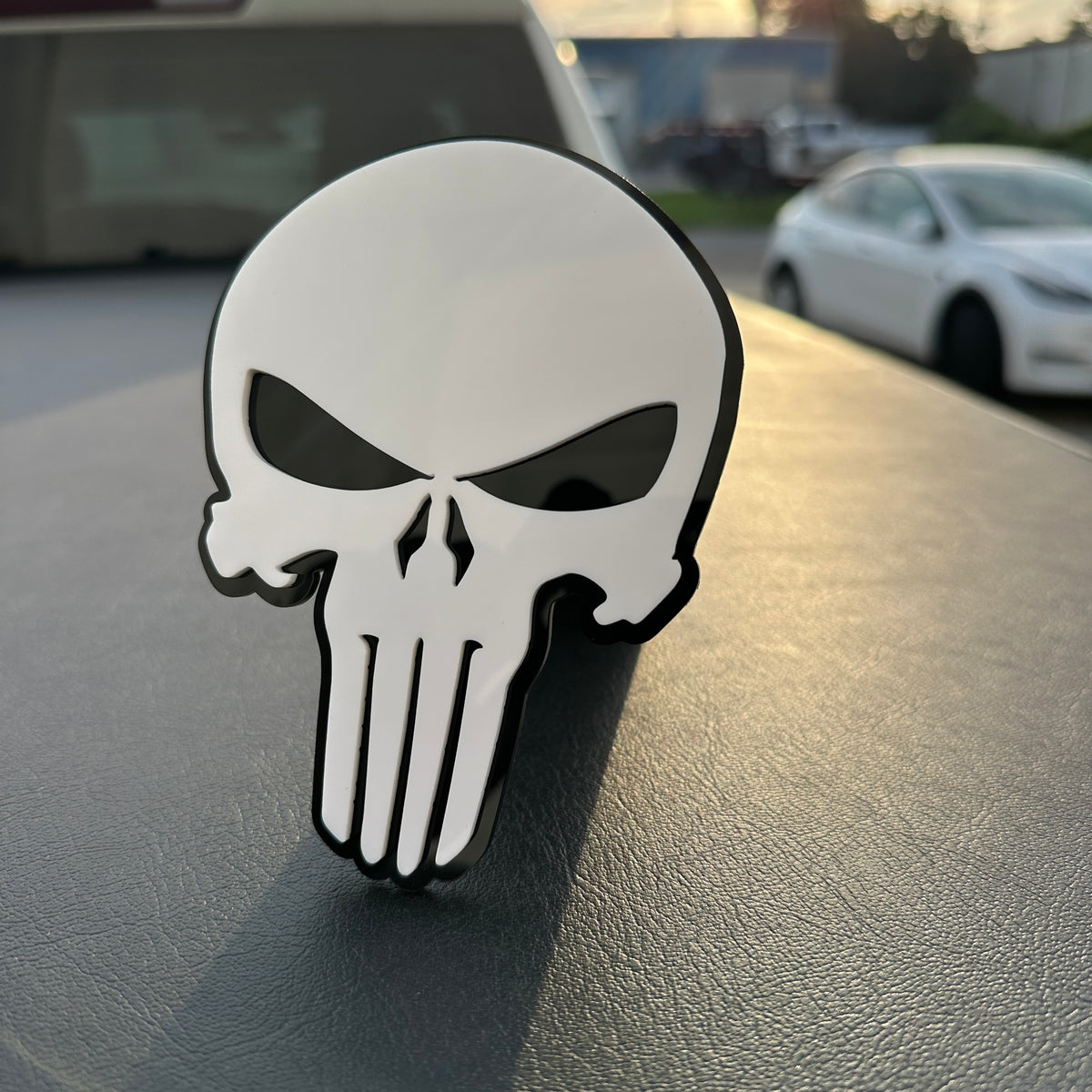 White and black Punisher skull car badge emblem with bold layered design