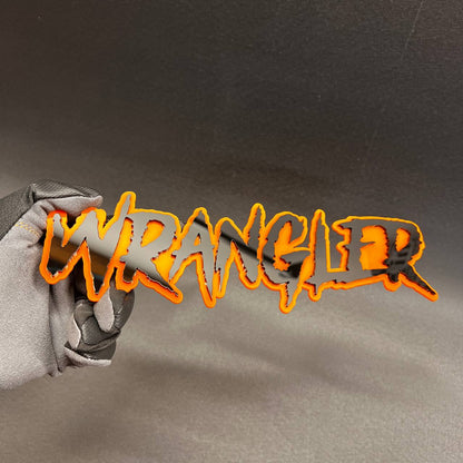 3D Wrangler text emblem with orange acrylic outline and black face.