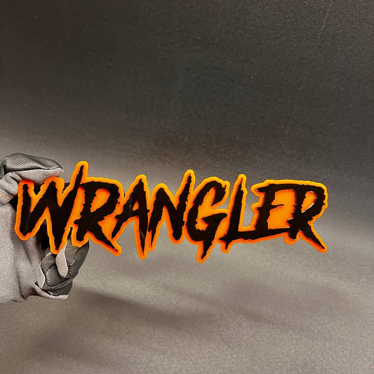 Wrangler custom text car badge in black with orange outline for vehicle exterior.