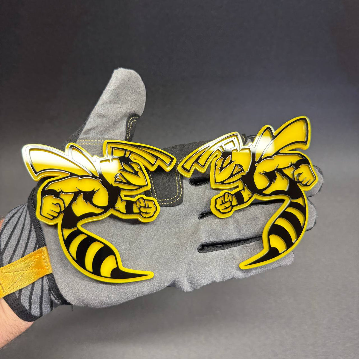 Aggressive yellow jacket hornet car badge with raised fists and striped tail for Ford Mustang and F-150 styling.